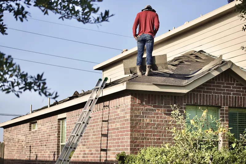 Professional roofer working on a residential roof in Lincoln Square